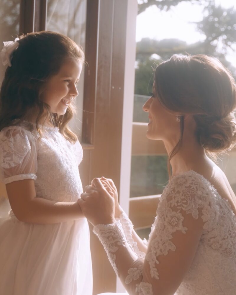 A noiva e a daminha de mãos dadas na manhã do casamento